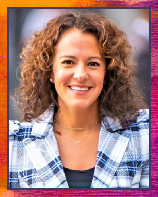 Hollie Velasquez headshot: woman with brown curly hair and plaid blazer
