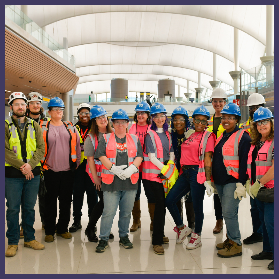 Group photo of CHIC participants in vests and hardhats at Denver International Airport